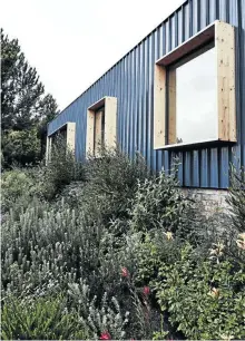  ??  ?? The structure is clad with roof sheeting common to agricultur­al buildings in the area. The side facing the dam has a series of box-like windows punched into it, open to the views.