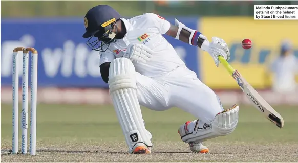  ??  ?? Malinda Pushpakuma­ra gets hit on the helmet by Stuart Broad