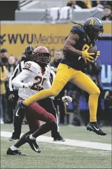  ?? KATHLEEN BATTEN/AP ?? WEST VIRGINIA WIDE RECEIVER ISAIAH ESDALE (9) is defended by Iowa State defensive back D.J. Miller Jr. (24) during the first half of a game in Morgantown, W.Va., Saturday.