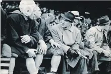  ??  ?? Coach Lew Hayman, centre, encourages his Toronto RCAF Hurricanes players during the 1942 Grey Cup game. He led them to an 8-5 victory over the Winnipeg RCAF Bombers, his fourth of five Cup wins.