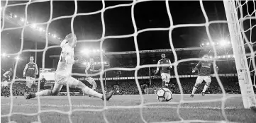  ??  ?? Everton’s Wayne Rooney scores their second goal during the English Premier League match against West Ham United at Goodison Park in Liverpool, north west England. — Reuters photo