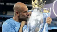  ?? ?? MANCHESTER City manager Pep Guardiola celebrates with the trophy after winning the Premier League last season. | Pictures: Reuters
