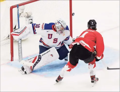  ?? Codie McLachlan / Getty Images ?? Canada’s Bowen Byram (4) takes a shot against U.S. goaltender Spencer Knight during the 2021 IIHF World Junior Championsh­ip gold-medal game at Rogers Place last week in Edmonton.