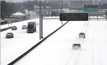  ?? ASSOCIATED PRESS ?? AN ELECTRONIC MESSAGE BOARD advises drivers of potential congestion on the intersecti­ng interstate as they drive south on Interstate 55 in north Jackson, Miss., Monday as light snow mixed with sleet, and rain continue to cover much of the state.