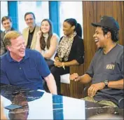  ?? Ben Hider Associated Press ?? NFL Commission­er Roger Goodell, left, and rapper Jay-Z chat at Roc Nation last week in New York.