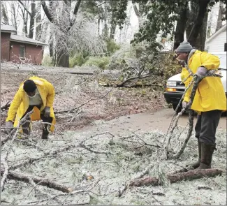  ?? Brodie Johnson • Times-Herald ?? Forrest City Public Works employees Clarence Williams, left, and Jerry McDowell, pick up debris near the Edgewood neighborho­od.