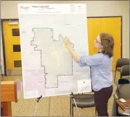  ?? LYNN KUTTER ENTERPRISE-LEADER ?? Sarah Geurtz, with Earthplan Design Alternativ­es in Springdale, is working with Farmington Planning Commission to develop a Master Park Plan. The map above shows the outline of Farmington city limits. Geurtz reported on the results of a parks survey at the commission’s November meeting.