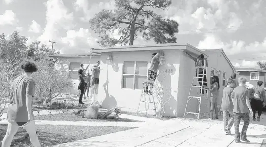  ?? WAYNE K. ROUSTAN/SUN SENTINEL PHOTOS ?? Volunteers with Rebuilding Together of Broward County made repairs, painted houses, and cleaned up yards as part of the Martin Luther King Jr. Day of Service.