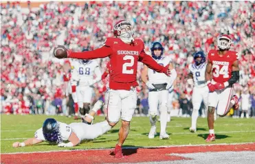  ?? Brian Bahr/getty Images ?? Oklahoma’s Peyton Bowen celebrates after scoring a touchdown off a 45-yard intercepti­on return past the diving reach of TCU center John Lanz on Friday.