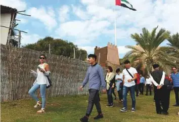  ?? Abdul Rahman/Gulf News ?? Tourists at the UAE Heritage Village of the Emirates Heritage Club at the Breakwater in Abu Dhabi. The emirate is investing heavily to boost tourism, infrastruc­ture and retail sectors.
