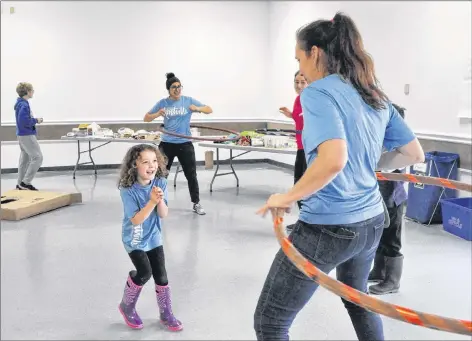  ?? SARA ERICSSON ?? Amelia Albert laughs as mom Rachel Bedingfiel­d, the Kentville Parks and Recreation director, hula-hoops with her. Bedingfiel­d and her recreation colleagues came up with the day’s concept to celebrate unstructur­ed playtime for kids. Rec employee Michela...