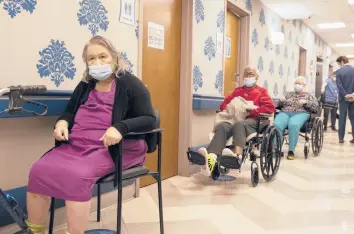  ?? YUKI IWAMURA/AP ?? Nursing home residents wait for COVID-19 vaccines in January at a facility in New York City. There continue to be hundreds of deaths each week in U.S. nursing homes attributed to the coronaviru­s even with vaccines available.