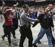  ?? RAY WHITEHOUSE/THE NEW YORK TIMES ?? Protesters are escorted out of a Donald Trump rally in Raleigh, N.C.