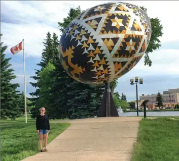 ??  ?? Rhiannon in front of the world’s largest pysanka in Vegreville, Alta.