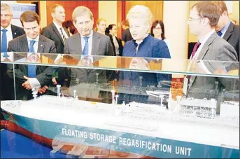  ??  ?? This file photo shows EU commission­er for Regional Policy Johannes Hahn (second left) and Lithuanian President Dalia Grybauskai­te (second right) looking at a model of the world’s first new-build liquefied natural gas (LNG) floating storage...