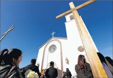  ?? Photograph­s by Al Seib Los Angeles Times ?? FAMILY and friends attend funeral services last week at Our Lady of Guadalupe Church in Delano for Santos Hilario Garcia and Marcelina Garcia Profecto, who died in a crash while f leeing immigratio­n agents in March.