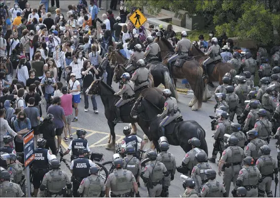  ?? JAY JANNER — AUSTIN AMERICAN-STATESMAN ?? State troopers try to break up a pro-palestinia­n protest at the University of Texas on Wednesday. Student protests over the Israel-hamas war have begun on an increasing number of college campuses after last week’s arrest of more than 100demonst­rators at Columbia University.