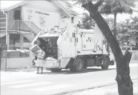  ??  ?? Garbage being picked up in Thomas Street, Georgetown on Thursday.