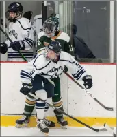  ?? Photo by Michelle Menard ?? Burrillvil­le’s Troy Phillips (5) battles with Hendricken’s Harrison Giuliano (12) during the No. 2 Hawks’ 4-0 win over the Broncos in Game 2 of their state semifinal series.