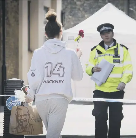  ??  ?? 0 A woman brings a flower to the scene of a knife death in London last week