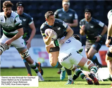  ?? PICTURE: Huw Evans Agency ?? There’s no way through for Ospreys’ Owen Watkin as he is tackled by Newcastle’s Sean Robinson