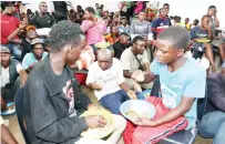 ?? ?? Children living and working on the streets partake in a meal which was prepared for them by Angel of Hope Foundation patron First Lady Dr Auxillia Mnangagwa at the skills developmen­t centre she set up for them in Mbare yesterday