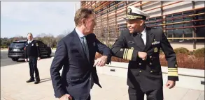  ?? Jessica Hill / Associated Press file photo ?? U.S. Surgeon General Vice Admiral Jerome M. Adams, right, bumped elbows with Gov. Ned Lamont in early March, before face mask protocols were set. Lamont on Thursday announced the city of New London is the state’s latest COVID-19 hot spot.