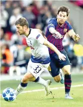  ?? AFP PHOTO ?? Tottenham Hotspur’s defender Ben Davies (left) vies with Barcelona’s striker Lionel Messi during the Champions League Group B football match at the Wembley Stadium in London.
