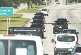 ?? THE ASSOCIATED PRESS ?? Motorcade vehicles transport President Donald Trump to Trump Internatio­nal Golf Club, in West Palm Beach, Fla., on March 30. Trump spent the weekend at his Mar-a-Lago estate.