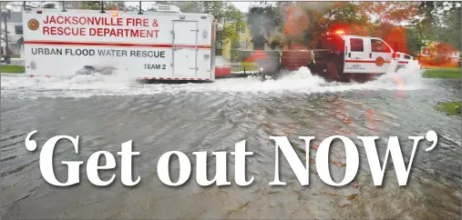  ?? AP PHOTO ?? Urban Flood Water Rescue Team 2, with the Jacksonvil­le Fire and Rescue Department, makes its way along San Marco Boulevard on the Southbank of downtown as Hurricane Irma passes by Monday in Jacksonvil­le, Fla.