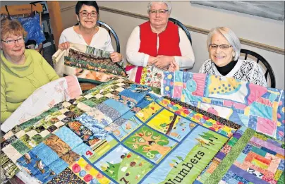  ?? DESIREE ANSTEY/JOURNAL PIONEER ?? Quilters Diane Williams, left, Edith Hogan, Elaine Burrows and Judy LaMarsh are shown with one of their creations.