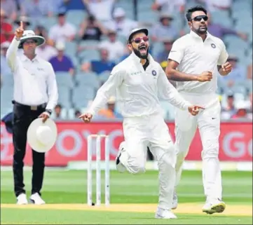  ?? REUTERS ?? Virat Kohli and Ravichandr­an Ashwin celebrate the dismissal of Marcus Harris (not in the picture) during the second day of the first Test between Australia and India at the Adelaide Oval on Friday. India are still 59 runs ahead.