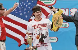  ?? Tina Fineberg / Associated Press ?? Matt Stonie wins Nathan’s Famous Hot Dog Eating Contest July 4, 2015, in New York. Stonie ate 62 hot dogs and buns in 10 minutes.