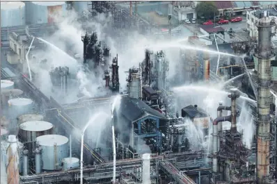  ?? KYODO VIA REUTERS ?? Firefighte­rs spray water on a blaze at the TonenGener­al Sekiyu K.K. refinery in Arida, Japan, on Monday. The fire erupted on Sunday evening, forcing authoritie­s to order the evacuation of nearly 3,000 people. The order was lifted early on Monday.