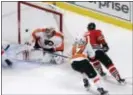  ?? CHARLES REX ARBOGAST — THE ASSOCIATED PRESS ?? Despite his top-shelf talent, securing a starting goalie role has always proven elusive for the Flyers’ Michal Neuvirth, here having a shot by Chicago’s Marian Hossa elude him Tuesday night.