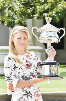  ??  ?? MELBOURNE: Germany’s Angelique Kerber poses with The Daphne Akhurst Memorial Trophy as she celebrates her victory in the women’s singles final on day fourteen of the 2016 Australian Open tennis tournament in Melbourne yesterday. — AFP