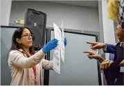  ?? JAHI CHIKWENDIU / WASHINGTON POST ?? A Broward County, Fla., election worker shows ballots that have been damaged and duplicated to election observers. Broward finished its hand recount in the U.S. Senate race Friday.