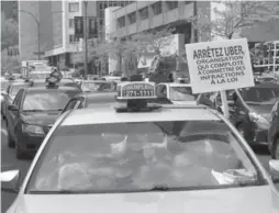  ?? RYAN REMIORZ/THE CANADIAN PRESS ?? Taxi drivers hold a demonstrat­ion in downtown Montreal against Uber on Tuesday. Toronto taxis are rolling out mobile updates to their apps to combat Uber’s growth.