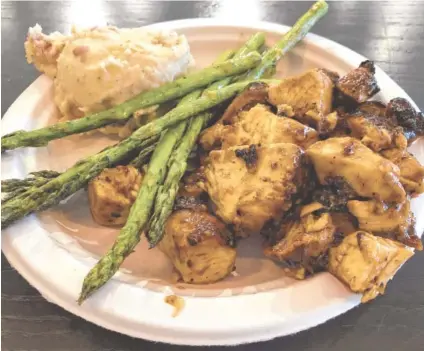  ?? PHOTO BY SUSAN PIERCE ?? Diced chargrille­d chicken is tossed with Brown Bag’s homemade teriyaki sauce for this $8.50 entree that came with choice of two sides, which were grilled asparagus and red-skin mashed potatoes.