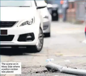  ??  ?? The scene on in Moss Side where a police cordon was placed