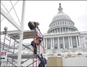  ?? ALEX WONG / GETTY IMAGES ?? Employees of the Architect of the Capitol build a scaffoldin­g at the West Front of the Capitol as constructi­on of the 2017 presidenti­al inaugural platform continues on Capitol Hill in Washington, D.C.