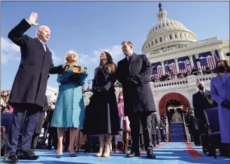  ?? Andrew Harnik / Associated Press file photo ?? Joe Biden is sworn in as the 46th president of the United States by Chief Justice John Roberts as Jill Biden holds the Bible during the 59th Presidenti­al Inaugurati­on at the U.S. Capitol on Jan. 20, 2021, as their children Ashley and Hunter watch.