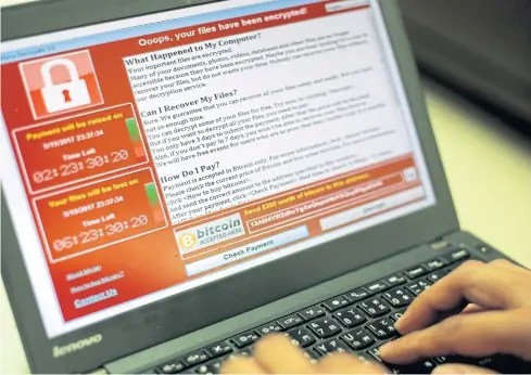  ??  ?? BUGGED OUT: A screenshot of a ransomware cyberattac­k on a laptop in Taiwan yesterday. The massive ‘WannaCry’ or ‘WCry’ attack hit computers in over 100 countries on Friday.