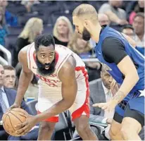  ?? JOHN RAOUX/AP ?? The Houston Rockets’ James Harden, left, considers his options under defensive pressure from the Orlando Magic’s Evan Fournier Friday night at Amway Center.