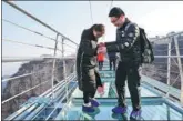  ?? ZHANG HAIQIANG / FOR CHINA DAILY ?? Tourists walk on a glass bridge in Pingshan county, Hebei province. The 488-meter bridge is about 218 meters above the ground.