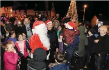  ??  ?? Crowd at turning on lights with Santa.