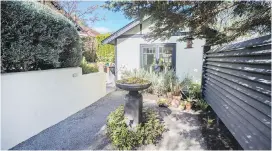  ??  ?? Above: The former driveway is now a haven for birds, filled with plants such as purple heart, mahonia and sedum.