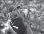  ?? Associated Press ?? Back swing: Jason Day, of Australia, watches his tee shot on the sixth hole during the third round of the Wells Fargo Championsh­ip at Quail Hollow Club in Charlotte, N.C., Saturday.