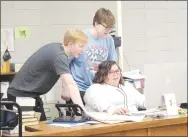  ?? Westside Eagle Observer/MIKE ECKELS ?? Deegan Brooks (left) and Ben Watkins review their schedules with Jayme Burden in the library during Decatur High School’s open house Aug. 11 in Decatur.