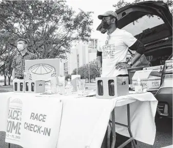  ?? Annie Mulligan / Contributo­r ?? Board member Daimian Hines greets guests Saturday during the inaugural Race For the Dome, a fun run hosted by the Astrodome Conservanc­y.